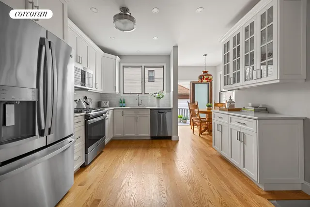 a dining room with furniture a rug and wooden floor