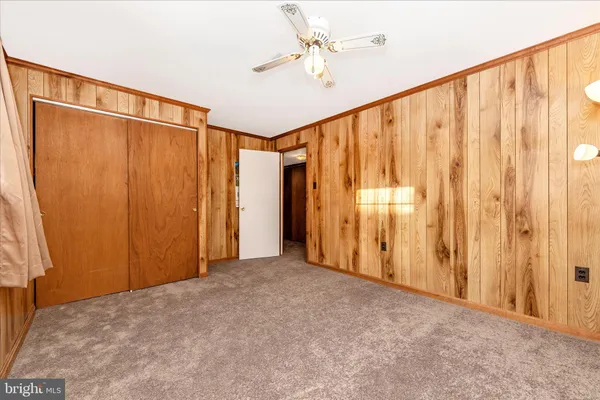 a view of a room with a large window and stairs