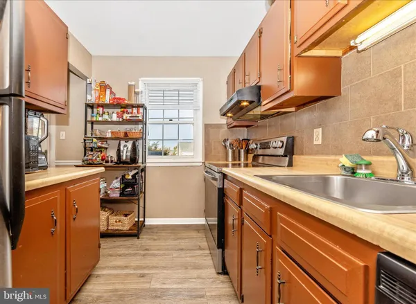 a kitchen with stainless steel appliances a sink and a stove