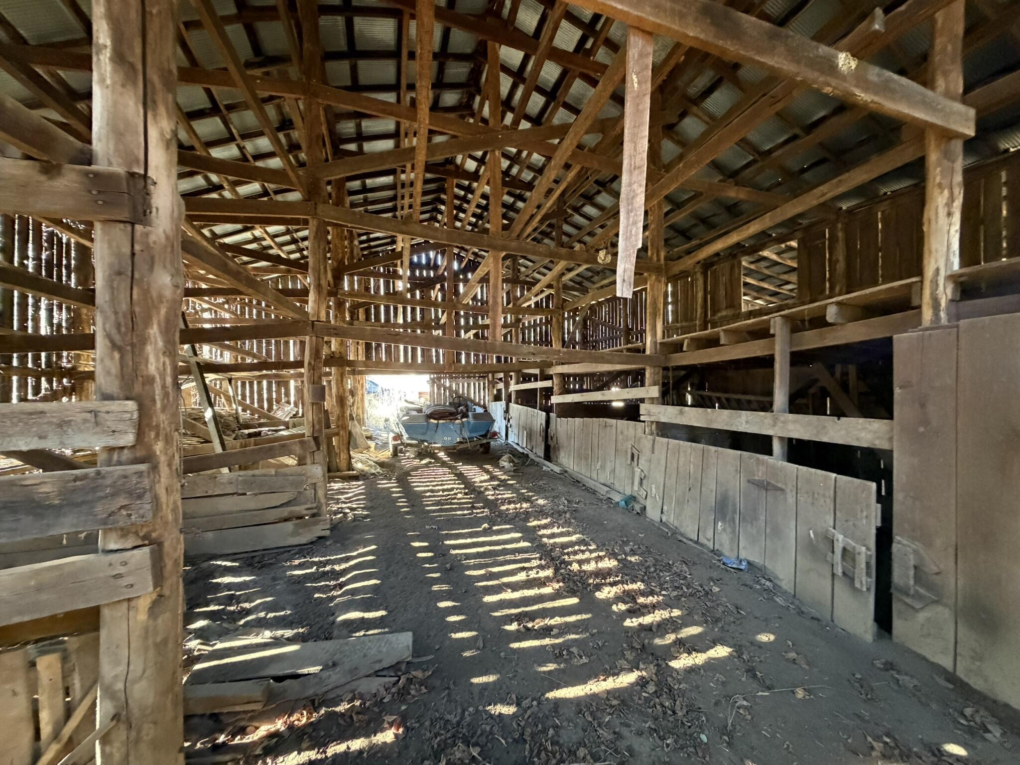 91 Quinton Callahan Road Booneville, KY 41314 - Photo 33 of 39 Spacious barn interior offering excellent potential for livestock, equipment storage, hay, or a variety of farm uses!