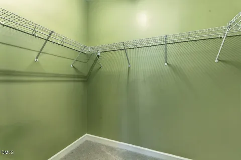 an empty room with a ceiling fan and a window