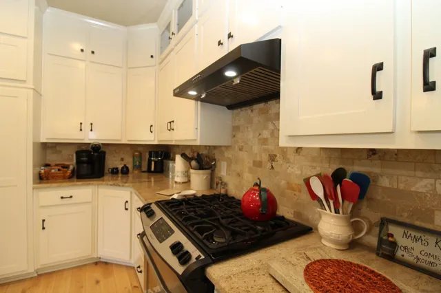a bedroom with a bed and a flat tv screen on dresser