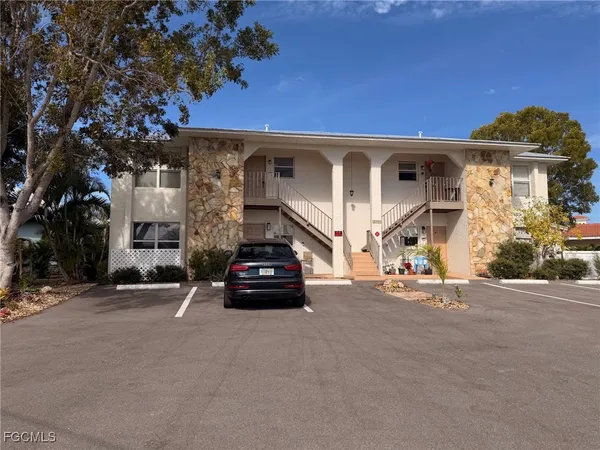 an outdoor view of a house with garage