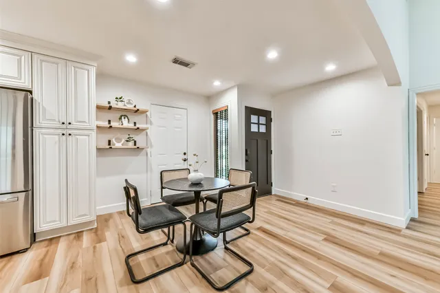 a living room with furniture and kitchen view