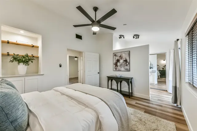 a en suite bathroom with a granite countertop sink a toilet and a mirror