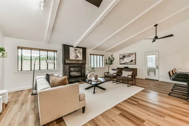 a living room with furniture and wooden floor
