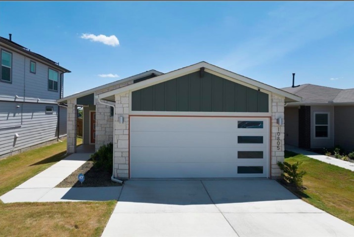 10805 Meris Lane Austin, TX 78754 - Photo 2 of 28 A striking modern facade welcomes with a crisp white garage door and clean-lined architectural details.