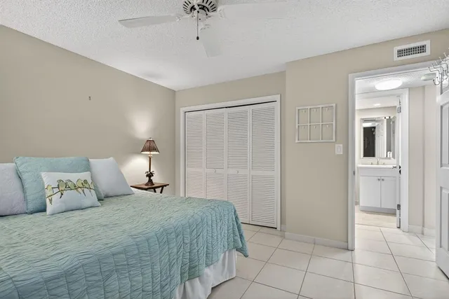 a living room with furniture a large window and chandelier