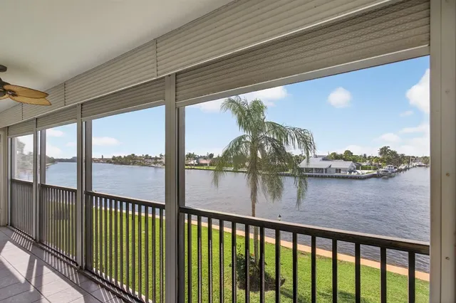 a bedroom with furniture and large windows