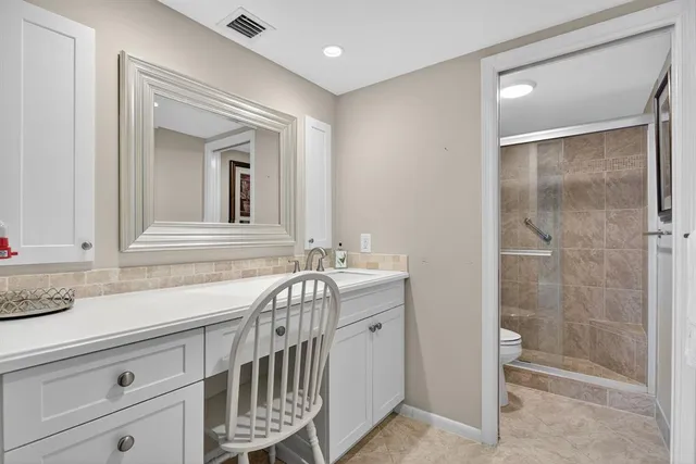 a view of a swimming pool with a garden and patio