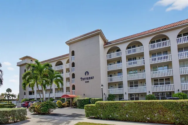 a kitchen with a refrigerator and white cabinets