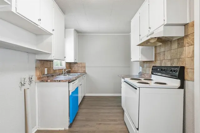 a kitchen with stainless steel appliances granite countertop a sink stove and cabinets