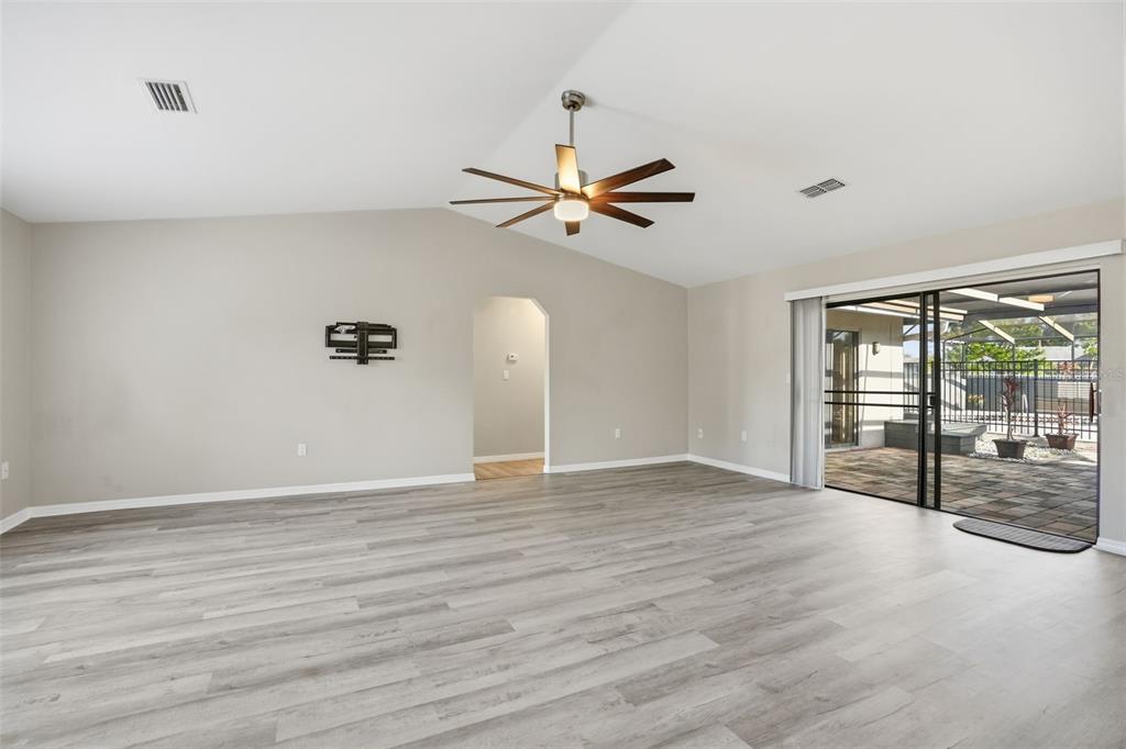 7026 Whitethorn Court Port Richey, FL 34668 - Photo 11 of 45 wooden floor in an empty room with a window