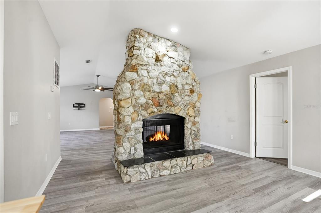 7026 Whitethorn Court Port Richey, FL 34668 - Photo 12 of 45 a living room with a fireplace