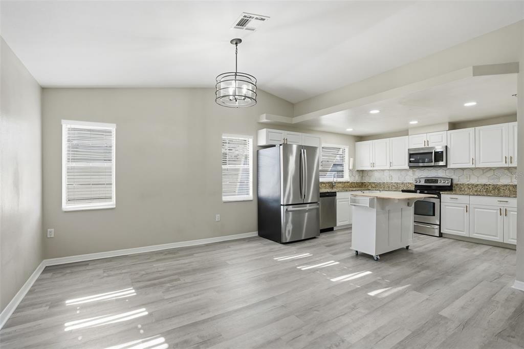 7026 Whitethorn Court Port Richey, FL 34668 - Photo 14 of 45 a view of kitchen with stainless steel appliances refrigerator stove microwave and cabinets