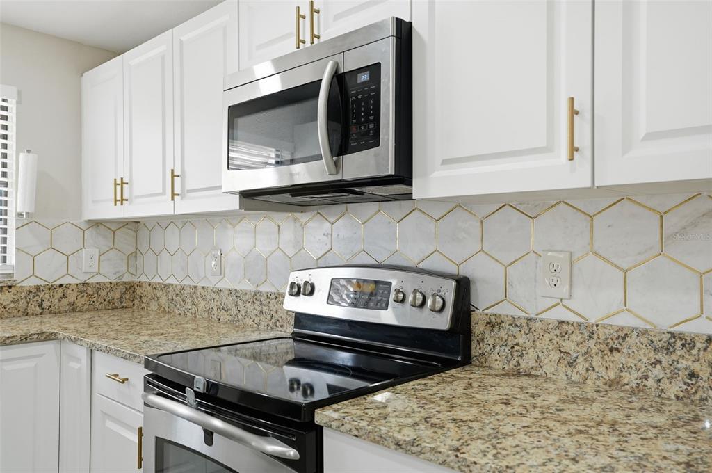 7026 Whitethorn Court Port Richey, FL 34668 - Photo 19 of 45 a stove top oven sitting inside of a kitchen
