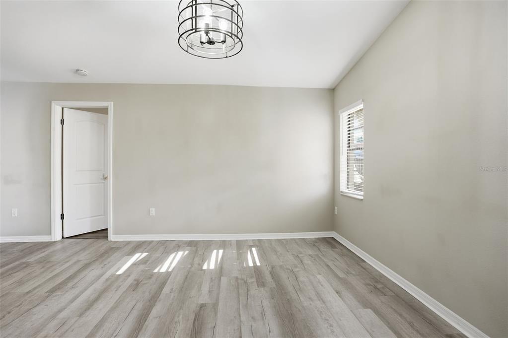 7026 Whitethorn Court Port Richey, FL 34668 - Photo 23 of 45 a view of room with hardwood floor and window