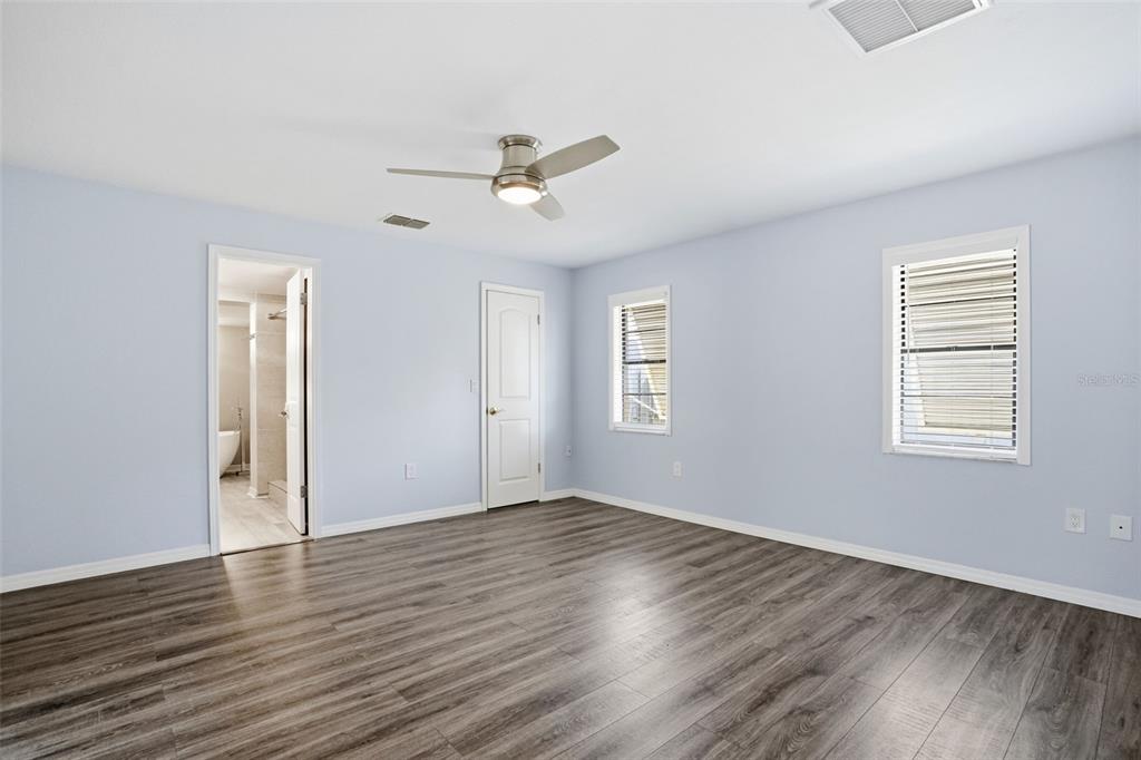7026 Whitethorn Court Port Richey, FL 34668 - Photo 25 of 45 a view of empty room with wooden floor and fan