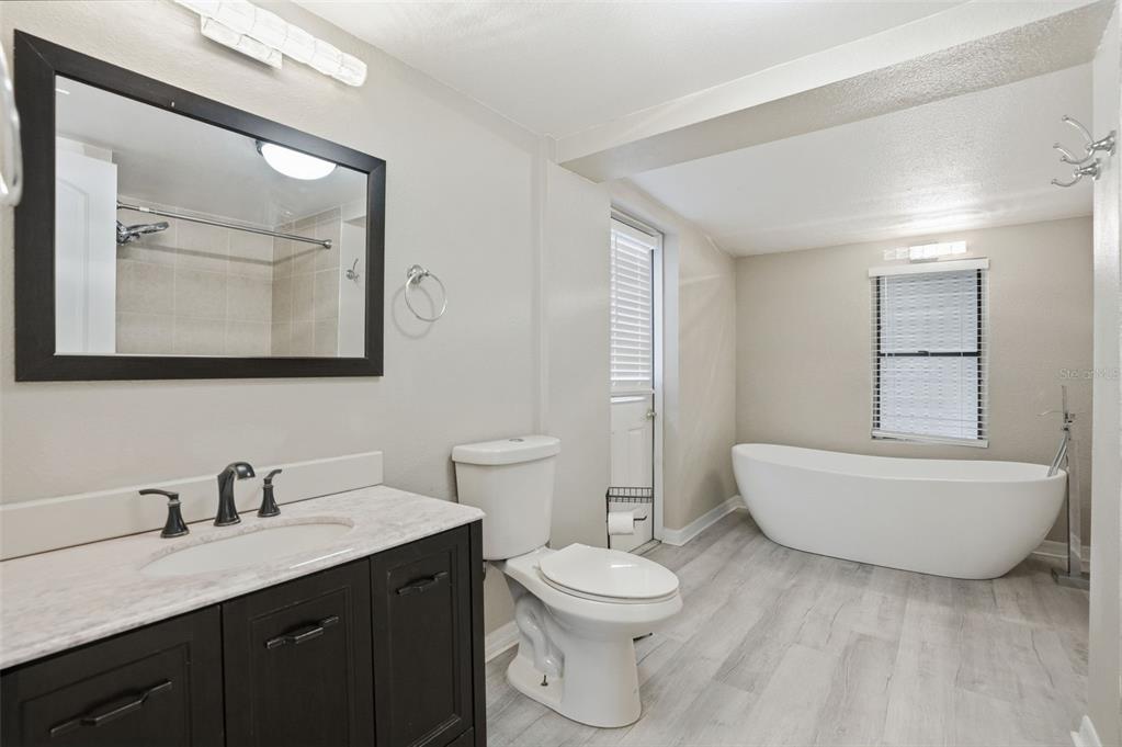 7026 Whitethorn Court Port Richey, FL 34668 - Photo 27 of 45 a bathroom with a toilet a sink a mirror and bathtub