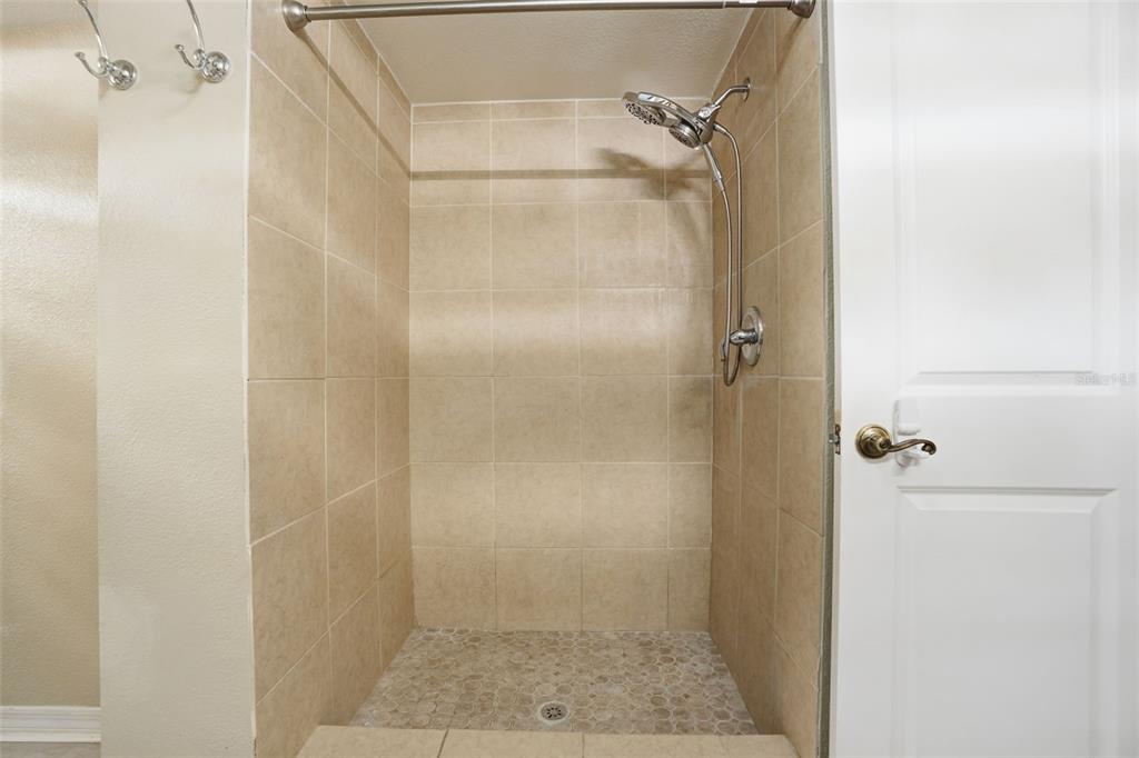 7026 Whitethorn Court Port Richey, FL 34668 - Photo 28 of 45 a bathroom with a glass shower door
