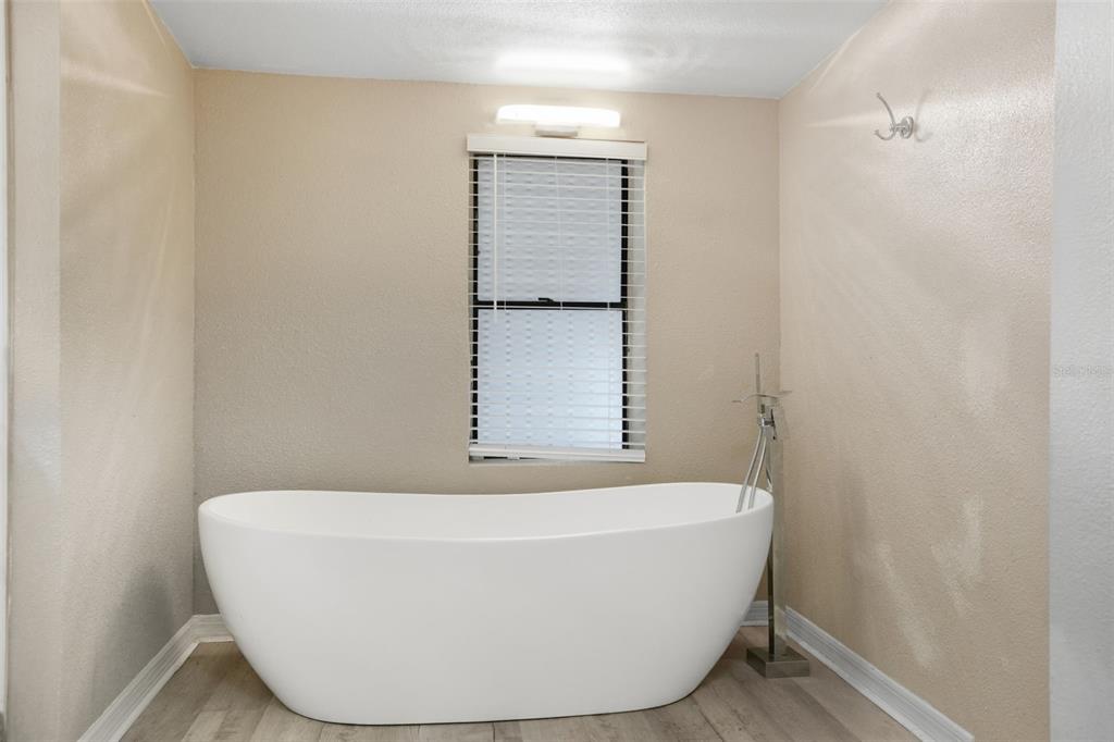 7026 Whitethorn Court Port Richey, FL 34668 - Photo 29 of 45 a white tub sitting next to a shower