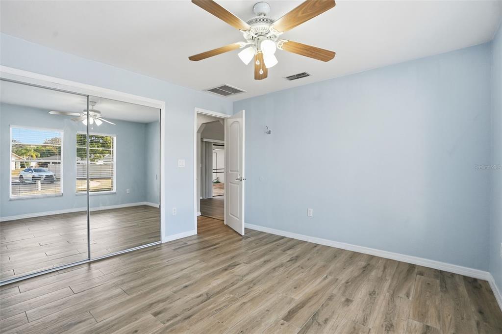7026 Whitethorn Court Port Richey, FL 34668 - Photo 33 of 45 wooden floor in an empty room with a window