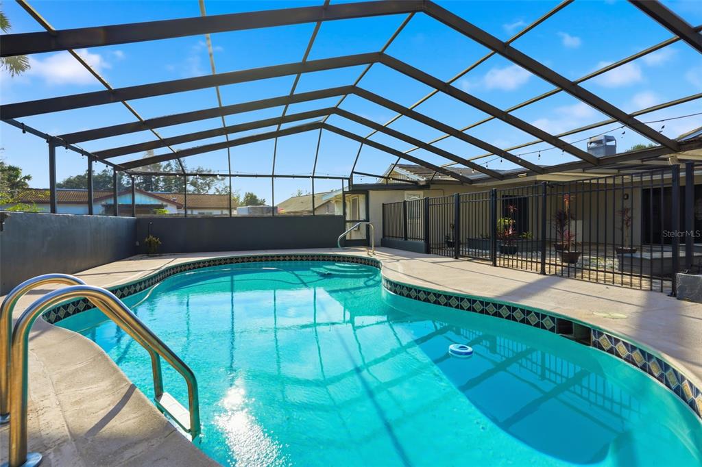 7026 Whitethorn Court Port Richey, FL 34668 - Photo 43 of 45 a view of a swimming pool with a patio