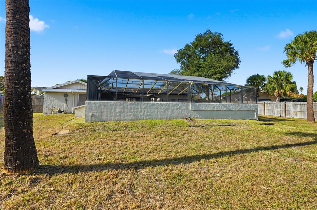 7026 Whitethorn Court Port Richey, FL 34668 - Photo 45 of 45 a view of a swimming pool with a yard