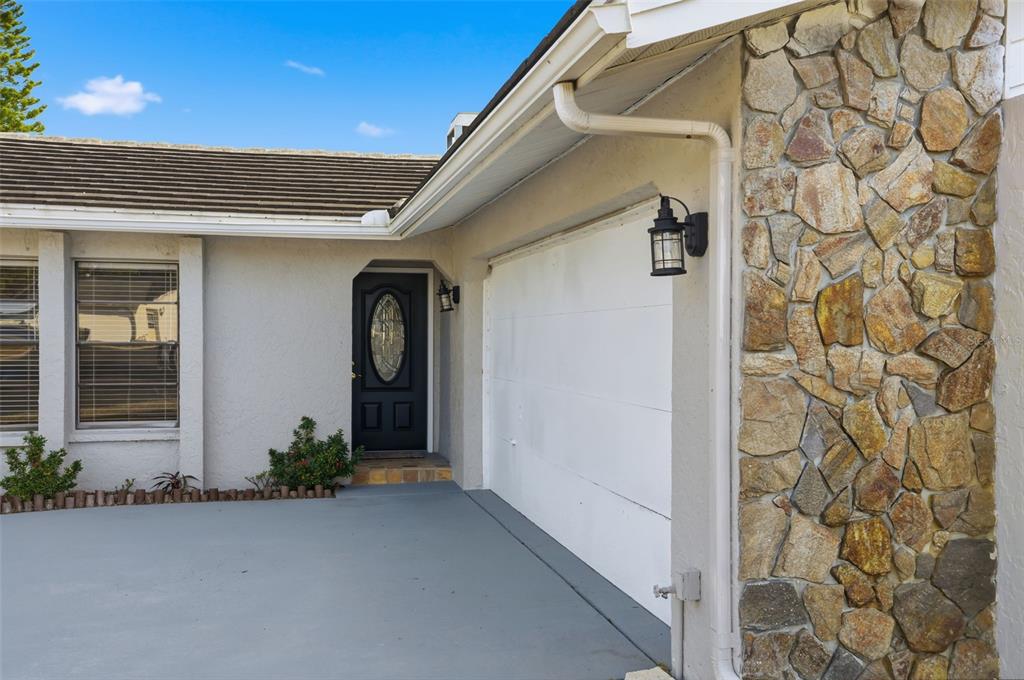 7026 Whitethorn Court Port Richey, FL 34668 - Photo 5 of 45 a front view of a house with garden