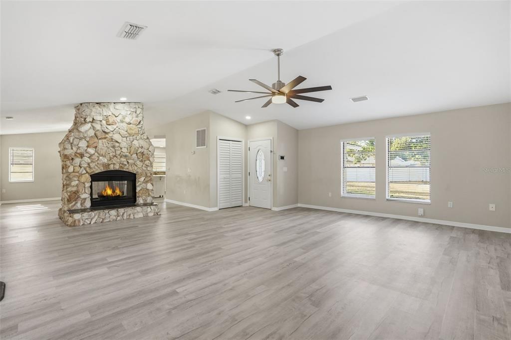 7026 Whitethorn Court Port Richey, FL 34668 - Photo 7 of 45 a view of an empty room with a window and fireplace