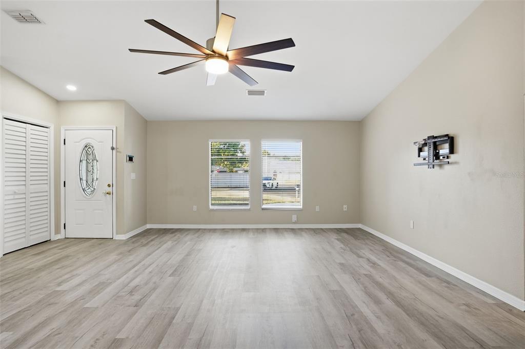 7026 Whitethorn Court Port Richey, FL 34668 - Photo 10 of 45 wooden floor in an empty room with a window