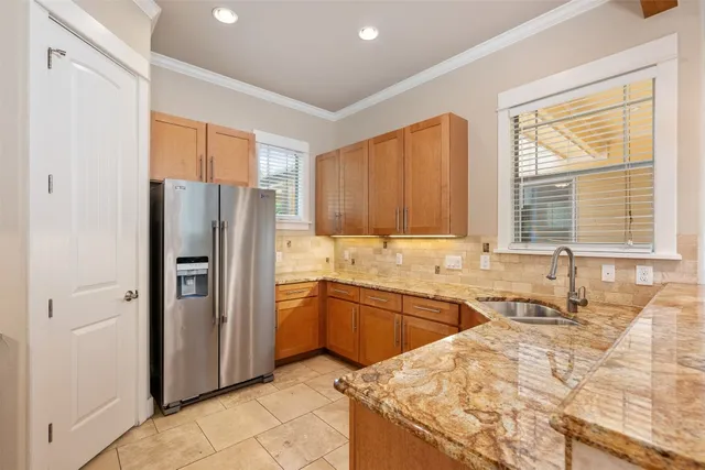 a kitchen with stainless steel appliances granite countertop a refrigerator and a sink