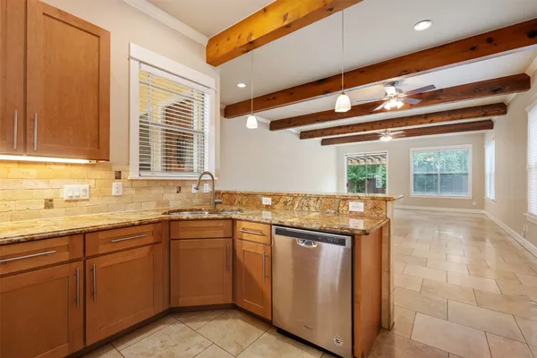 a kitchen with stainless steel appliances granite countertop a sink and a stove