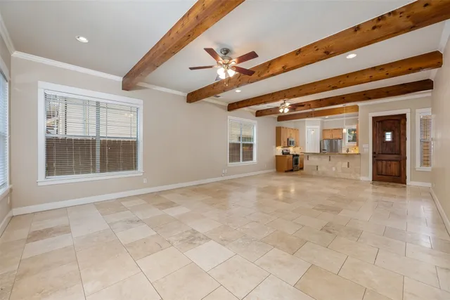 a view of empty room with furniture and fan
