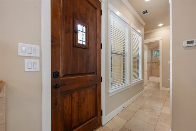 a view of a hallway with wooden floor and entryway