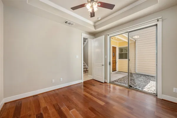 wooden floor in an empty room with a window