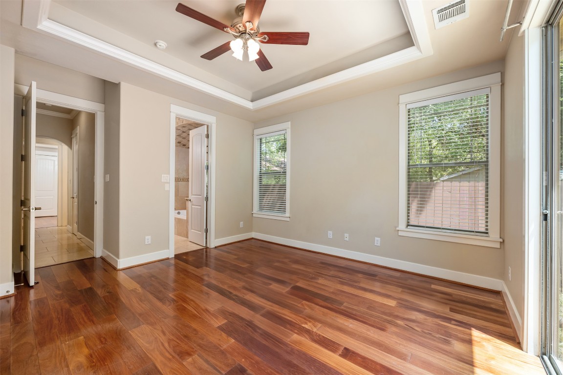 303 Zennia Street Austin, TX 78751 - Photo 21 of 40 a view of an empty room with wooden floor and a window