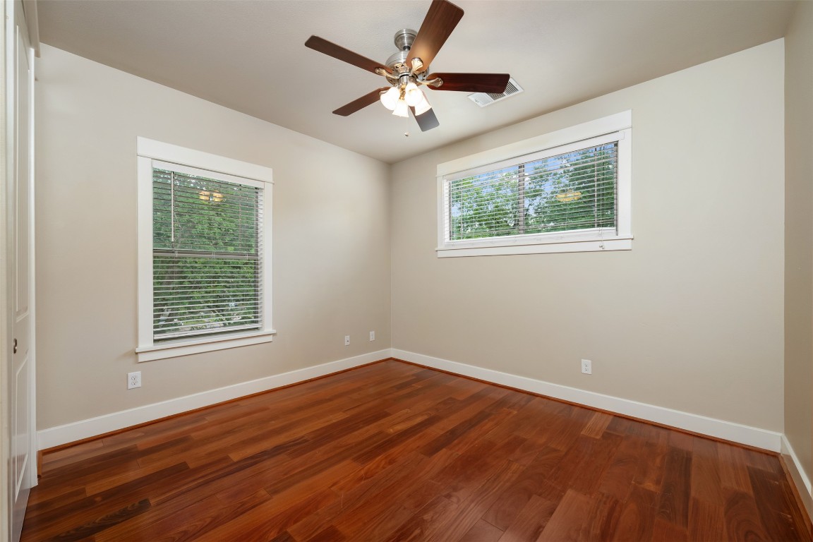 303 Zennia Street Austin, TX 78751 - Photo 28 of 40 a view of an empty room with wooden floor and a window
