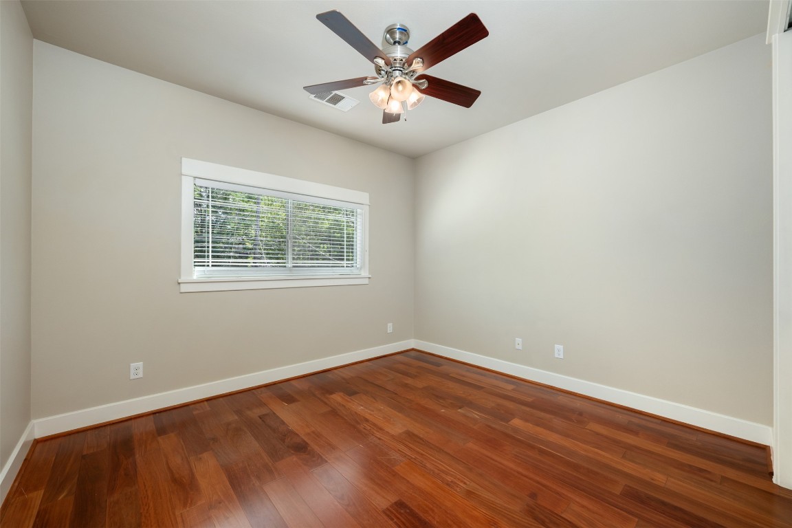 303 Zennia Street Austin, TX 78751 - Photo 36 of 40 a view of an empty room with window and wooden floor