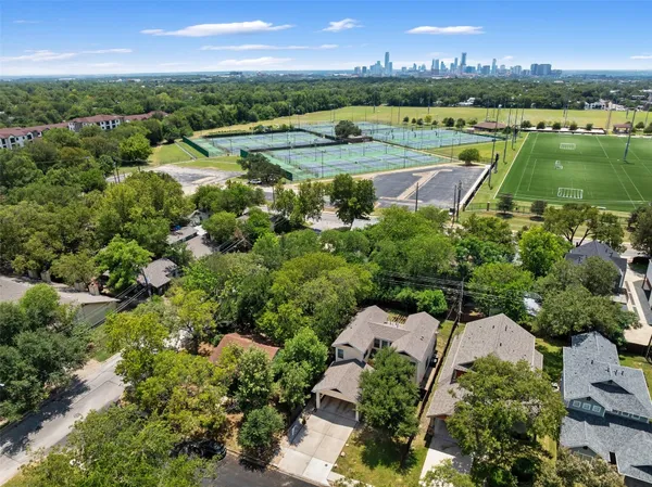 an aerial view of lake with residential houses with outdoor space and swimming pool