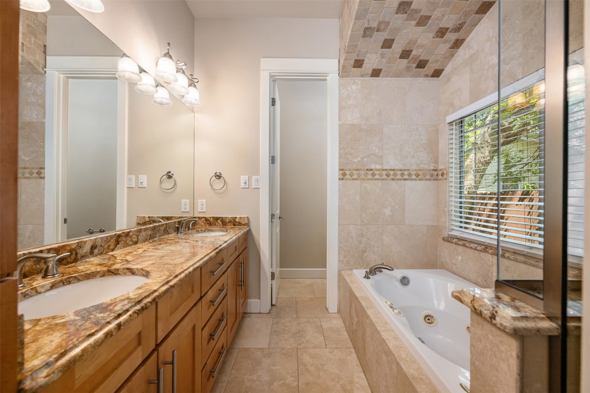 303 Zennia Street Austin, TX 78751 - Photo 5 of 40 a bathroom with a tub sink and mirror