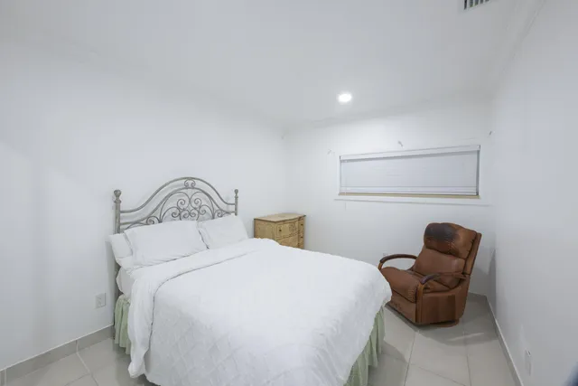 a bedroom with a bed and a chair