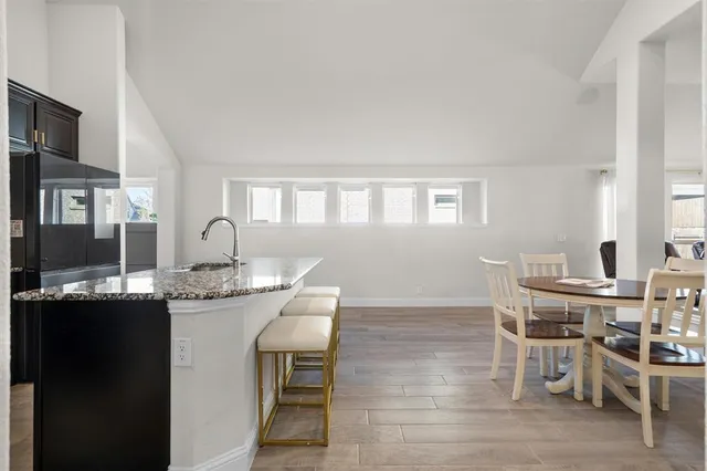 a view of a dining room with furniture and window