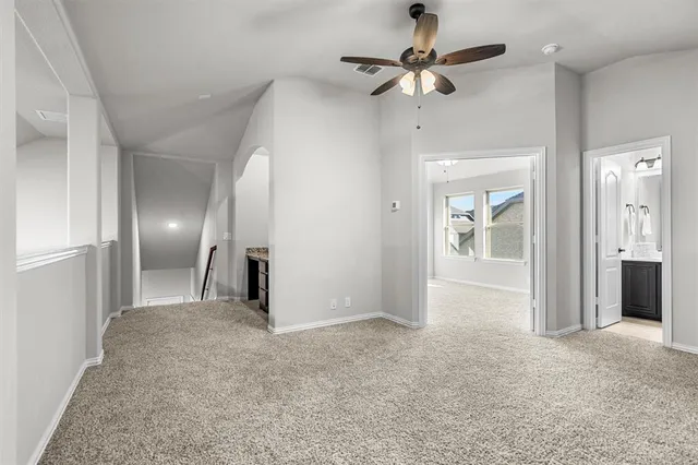 an empty room with fan and entrance