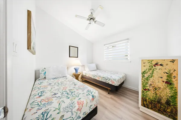 a bedroom with a bed and a potted plant