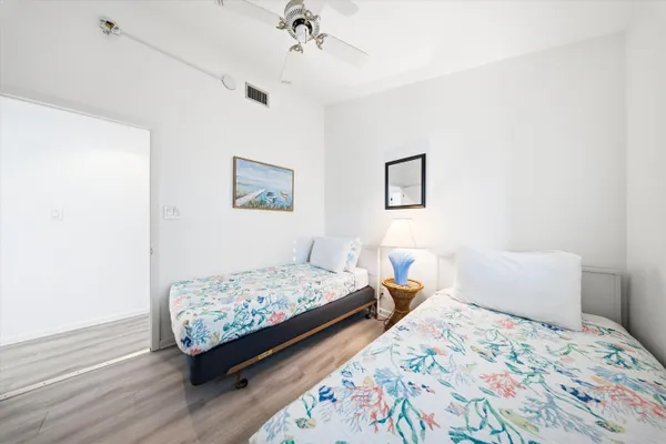 a bedroom with a bed and a painting on the wall