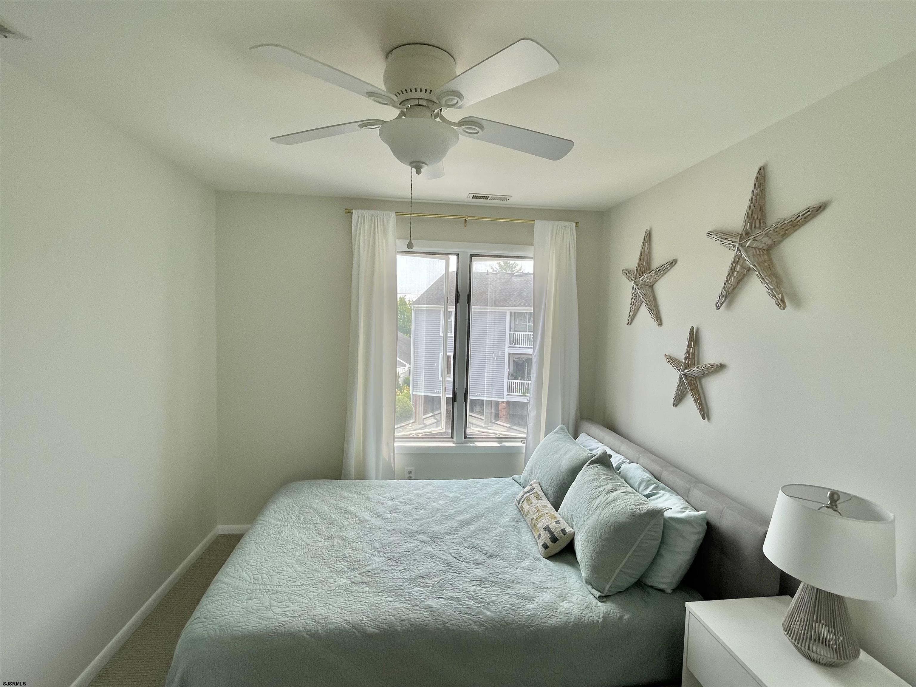 210 Harbour Cove, Unit 210 Somers Point, NJ 08244 - Photo 12 of 30 a bed sitting in a bedroom next to a window