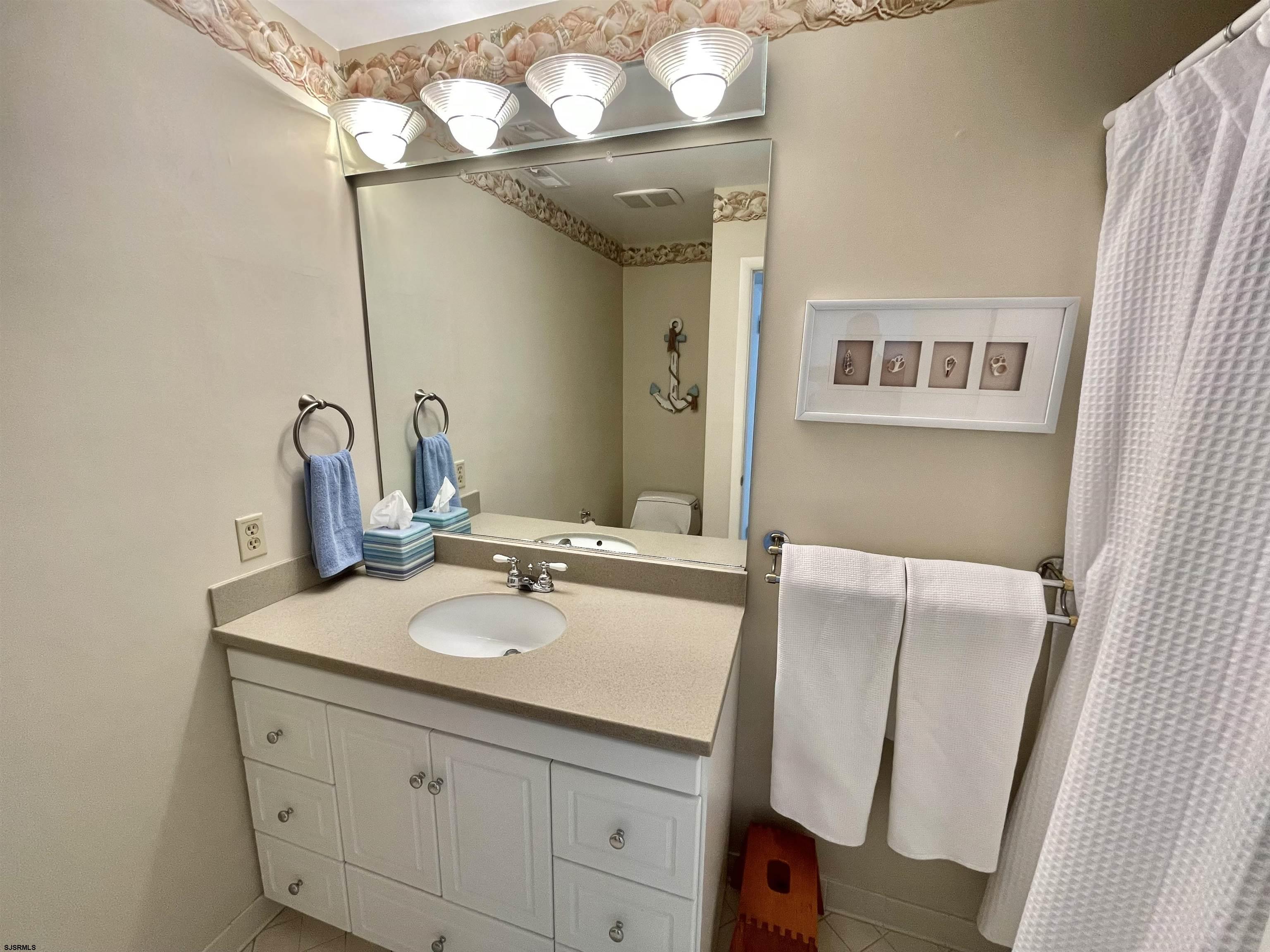 210 Harbour Cove, Unit 210 Somers Point, NJ 08244 - Photo 14 of 30 a bathroom with a sink and a mirror