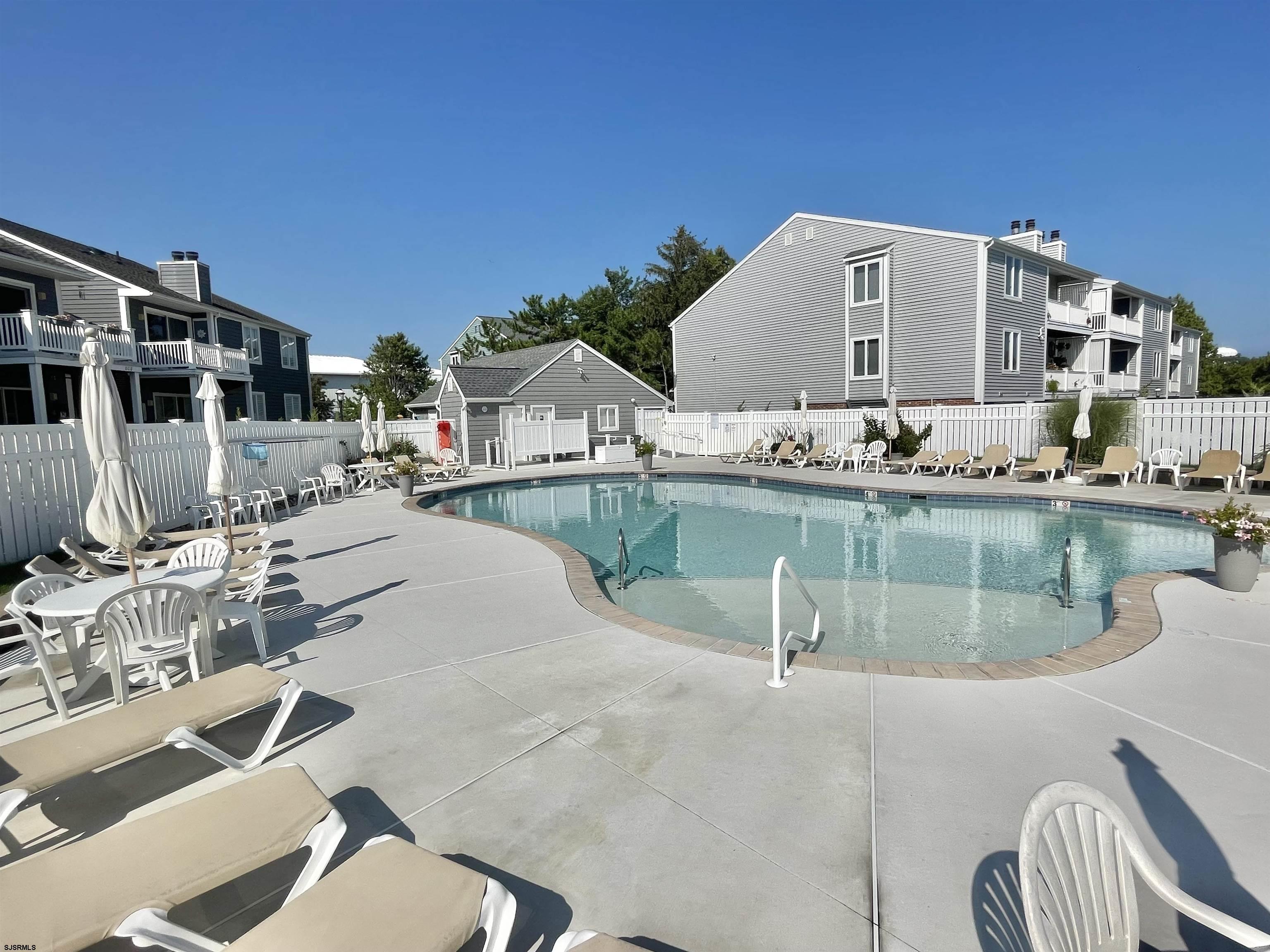 210 Harbour Cove, Unit 210 Somers Point, NJ 08244 - Photo 19 of 30 a swimming pool with outdoor seating and yard