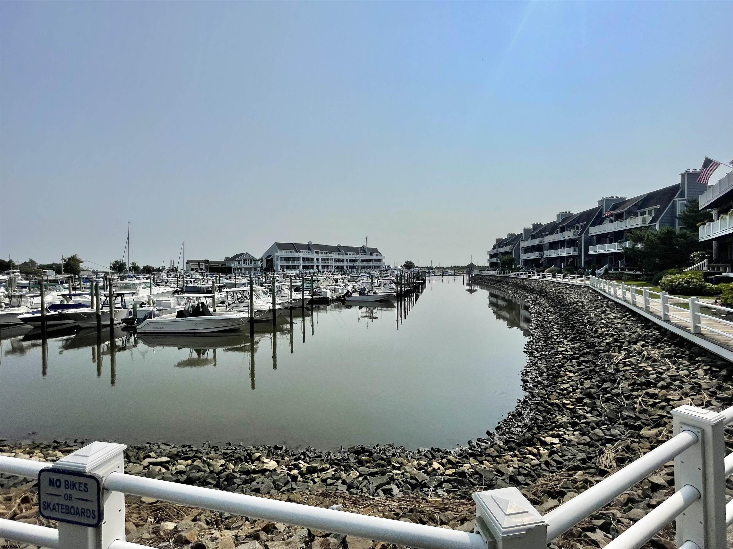 210 Harbour Cove, Unit 210 Somers Point, NJ 08244 - Photo 26 of 30 a view of a lake from a yard and a mountain view